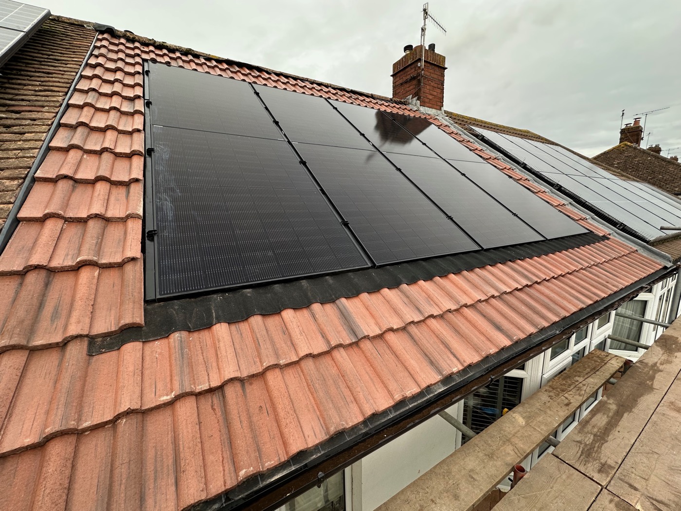 Finished in-roof solar panels sitting flush within the tiled roof of a house