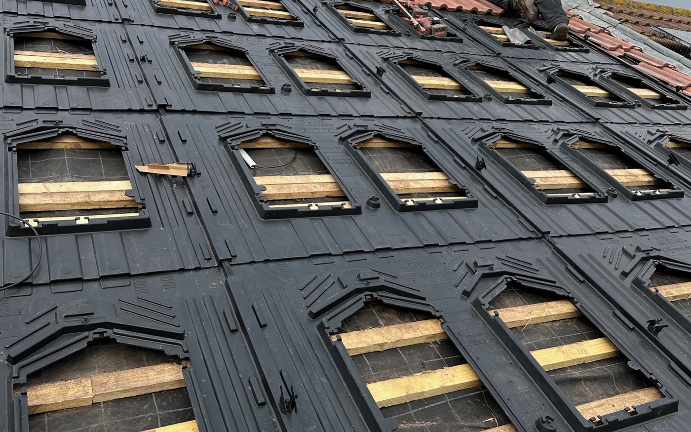 GSE in-roof mounting trays laid across the stripped roof before the panels are fitted