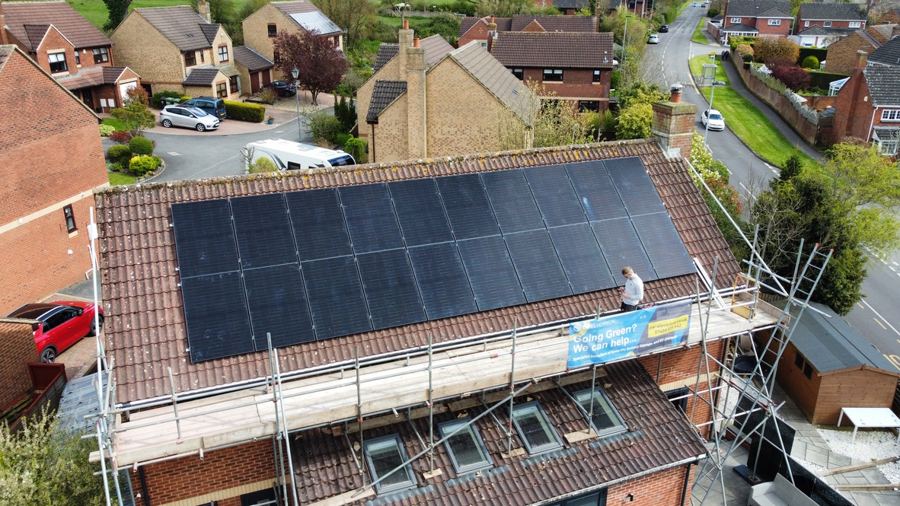 Drone photograph of a large solar array across a long roof
